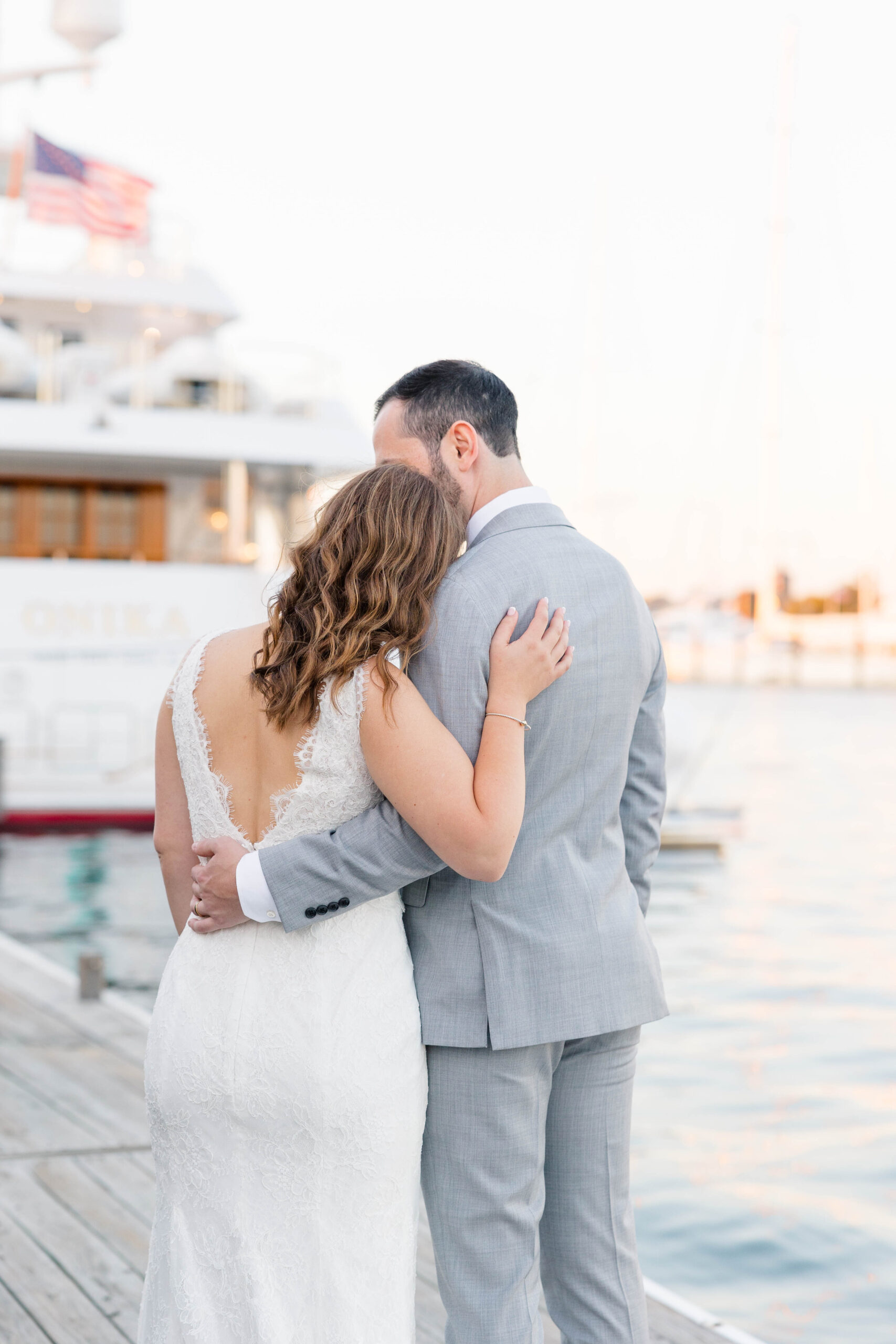 Newport Wedding Photographer and Videographer | Serving CT, RI, Massachusetts, and Surrounding New England Areas | Bride and groom embracing by the dock