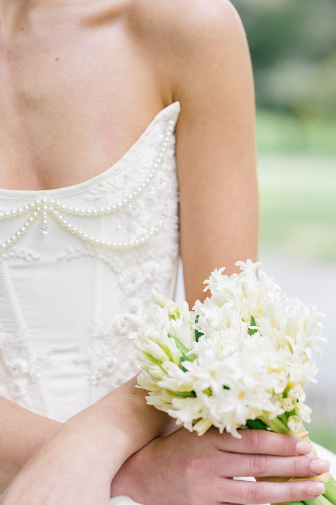 Wedding Photographer Newport RI and Wedding Videographer | Serving CT, RI, and New England Areas | Bride holding a bouquet of white flowers