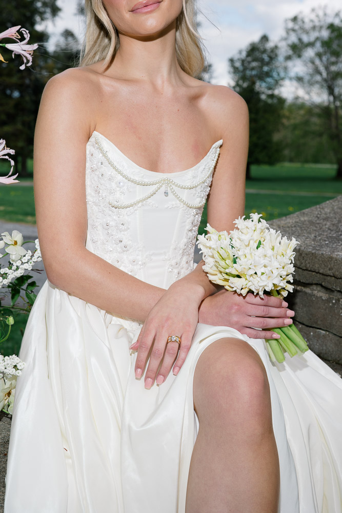 CT Wedding Photographer and Wedding Videographer | Serving Newport, RI, and New England Areas | Bride wearing a tube top wedding gown holding a white floral bouquet