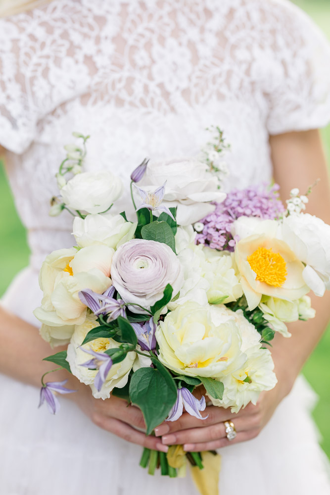 Connecticut Wedding Photographer and Wedding Videographer | Serving Newport, RI, and New England Areas | Bride holding a bouquet with hints of purple and yellow colors