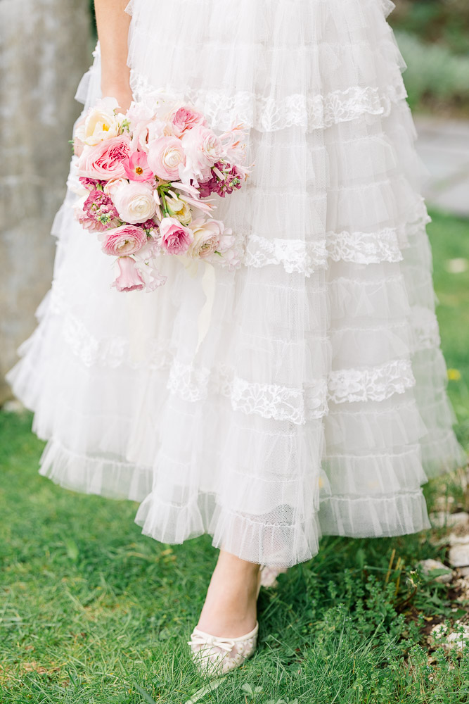 Newport Videographer and Wedding Photographer | Serving CT, RI, and New England Areas | Bride holding a pink and blush bouquet while walking on grass