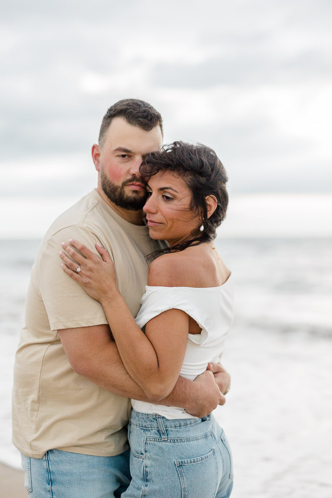 Engagement Photographer Newport RI and Videographer | Serving CT, RI, and New England Areas | Couple embracing on the beach