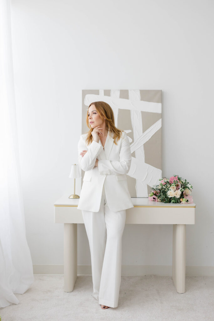 Branding Photographer CT and Videographer | Serving Newport, RI, and New England Areas | Woman standing with a bouquet for a branding shoot