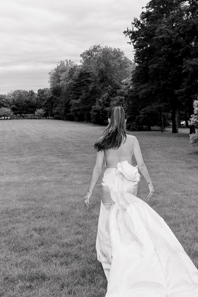 Wedding Photographers and Video CT | Serving Newport, RI, and New England Areas | Bride walking at the Wadsworth Mansion garden captured in black and white film-style