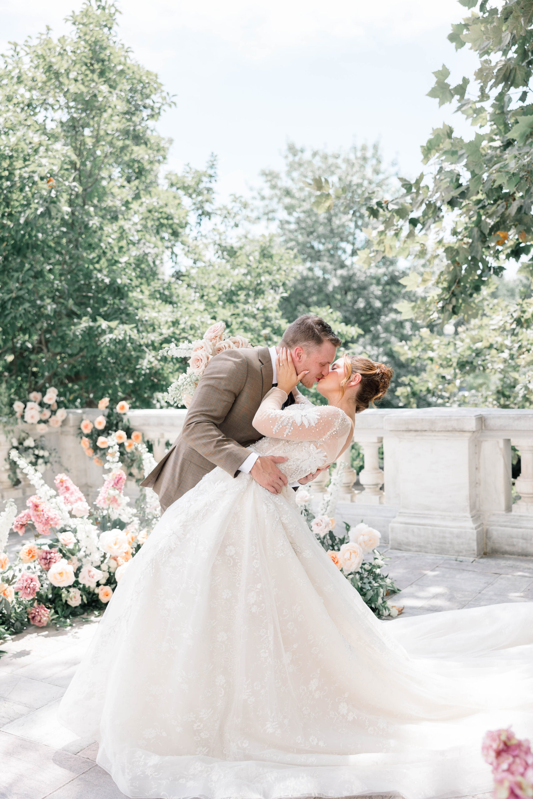 Newport Wedding Photographer and Videographer | Serving CT, RI, Massachusetts, and Surrounding New England Areas | Groom kissing bride while holding her waist