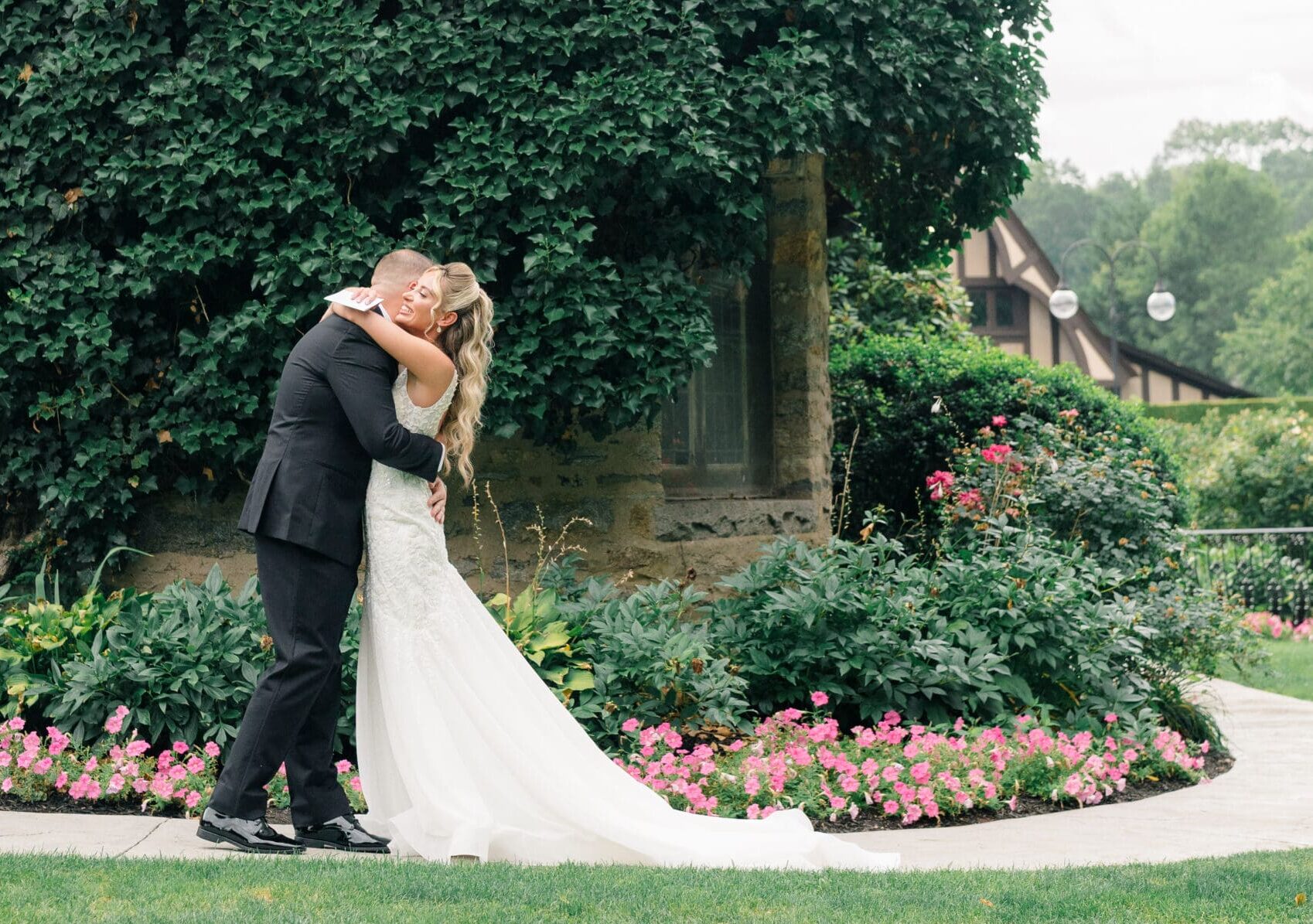 Couple embracing during a first look at a historic estate wedding venue