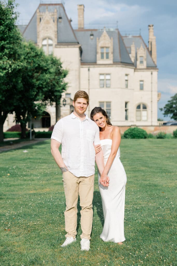 Couple standing together on the lawn at Ochre Court during a Newport engagement session.
