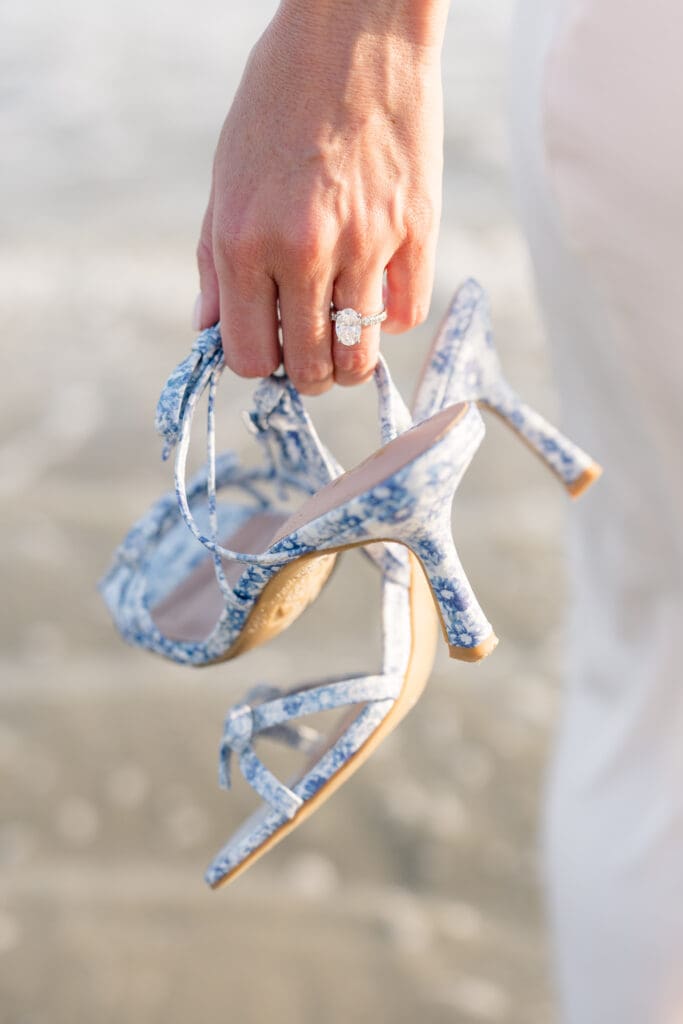 Engagement ring and blue heels photographed during a Newport engagement session.