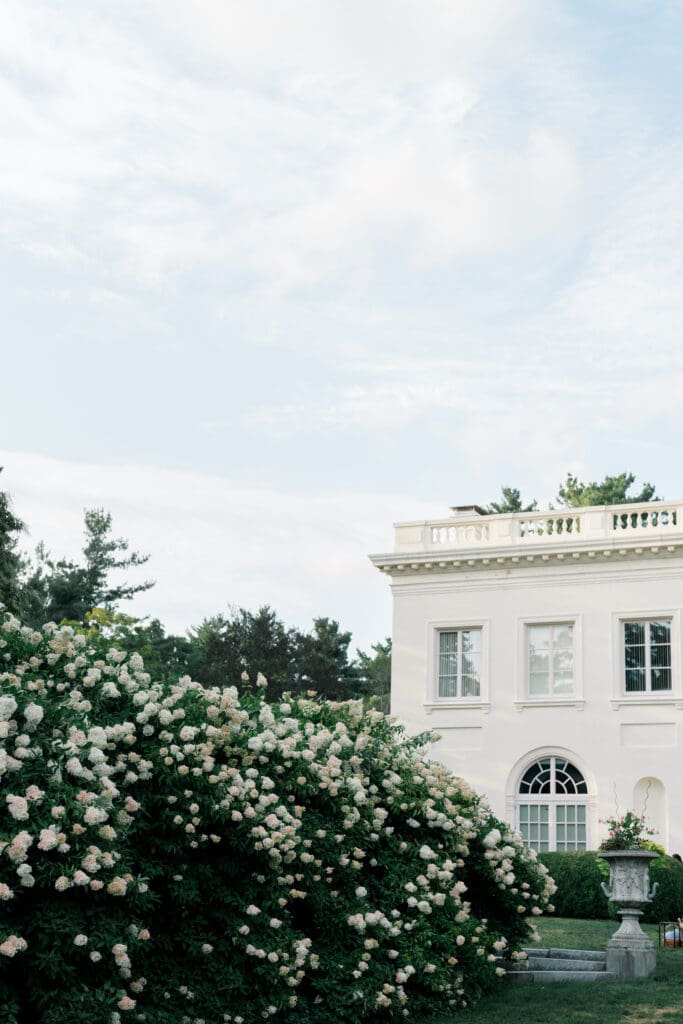 Wadsworth Mansion exterior with blooming white garden flowers at a Connecticut estate wedding venue